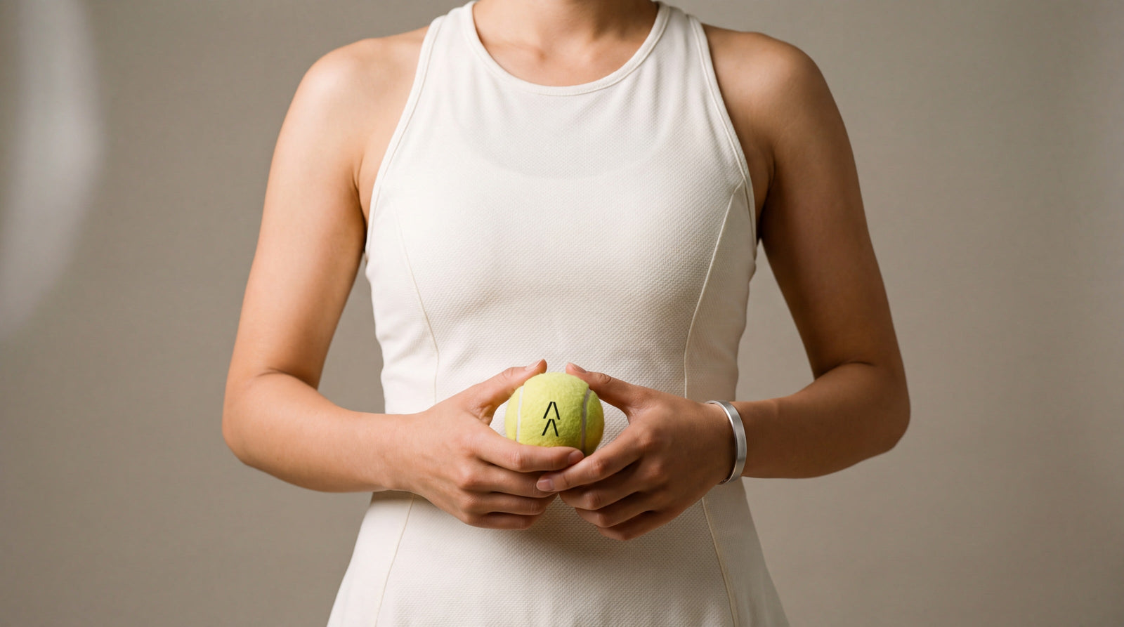 Tennis player holding a tennis ball marked with the Agena symbol